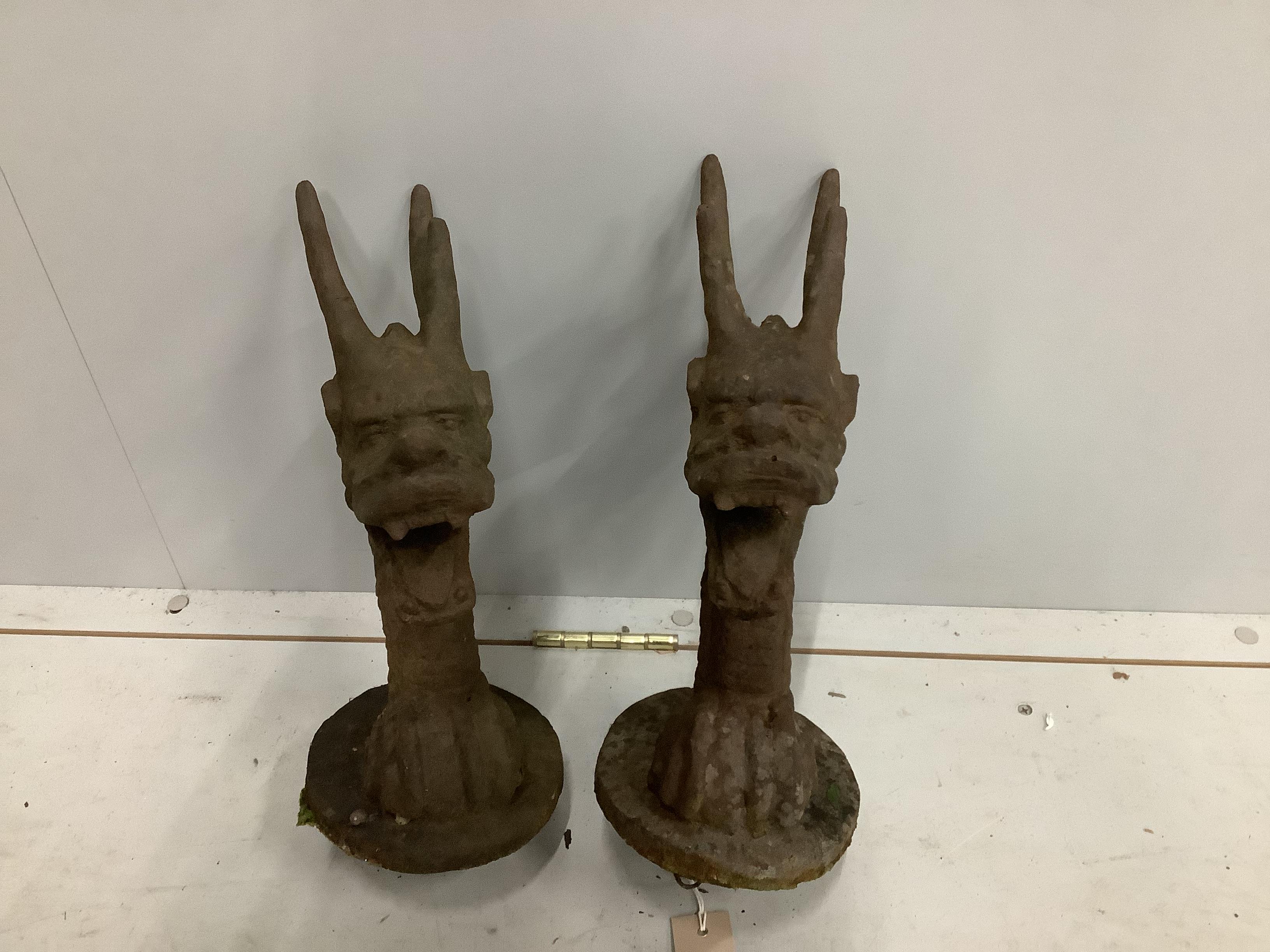 A pair of Victorian cast iron dragon head finials, height 36cm